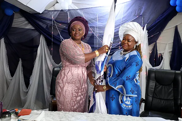 The immediate past President, Hajiya (Dr.) Aisha Nana Gambo Handing Over Flag of Office to The New NOWA National President, Mrs. Ijeoma Ogalla