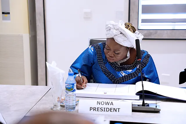NOWA National President, Mrs. Ijeoma Ogalla signing register during the NOWA courtesy visit to the Chief of Naval Staff, Vice Admiral EI Ogalla