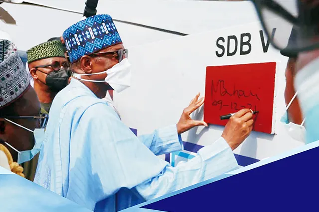 His Excellency, Former President Muhammadu Buhari, GCFR signing the keel for the construction of Seaward Defence Boat V during the commissioning ceremony of the newly acquired vessels for the Nigerian Navy