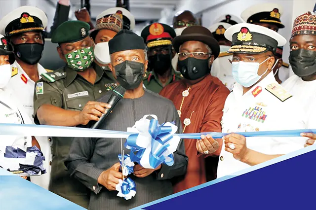 His Excellency, Yemi Osinbajo, GCON, SAN cutting the commissioning ribbon of the Falcon Eye Main Control Centre at the Naval Headquarters, Abuja